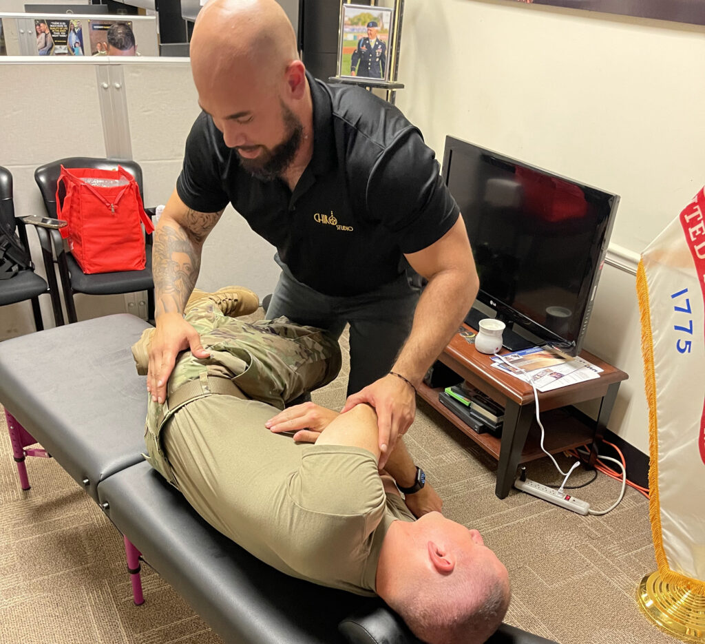 Dr Isidoro Acevedo Jr giving the arm man a hip pain treatment